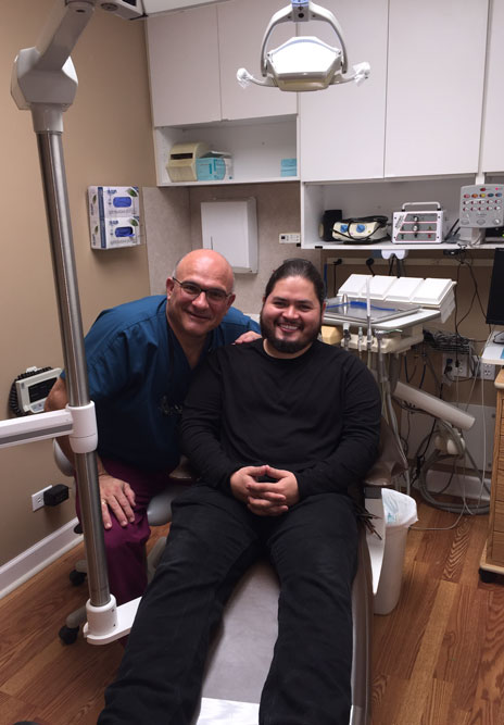 Dr Sal in Exam room with a patient after Dental Cleaning